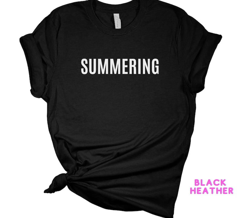 May include: Black heather t-shirt with the text "SUMMERING" printed in white on the front.