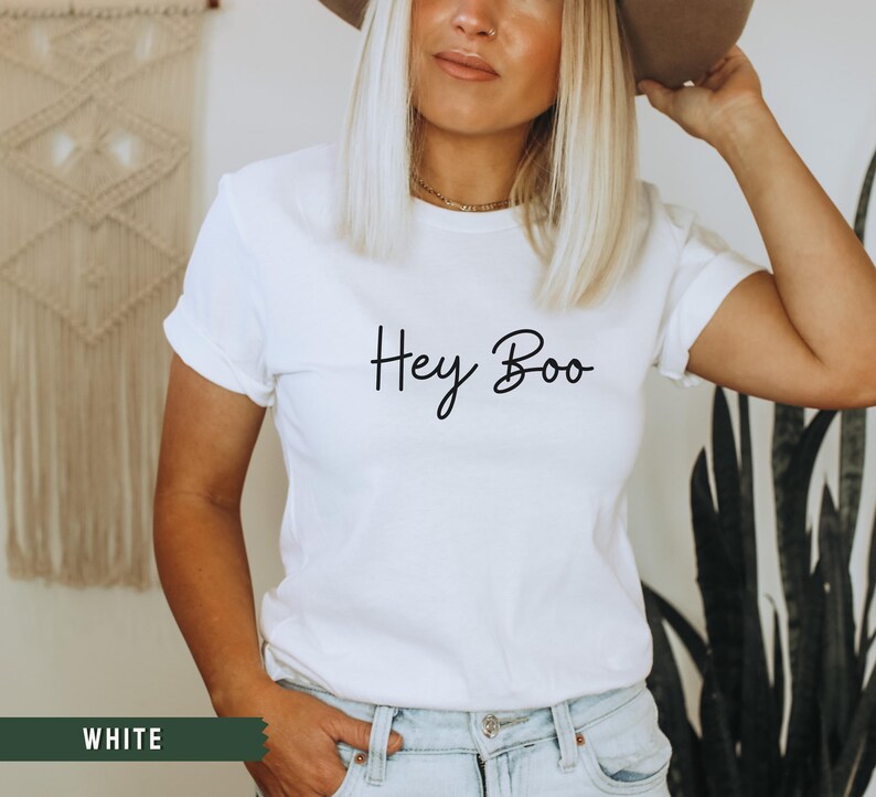 May include: White t-shirt with the text "Hey Boo" written in black cursive script.