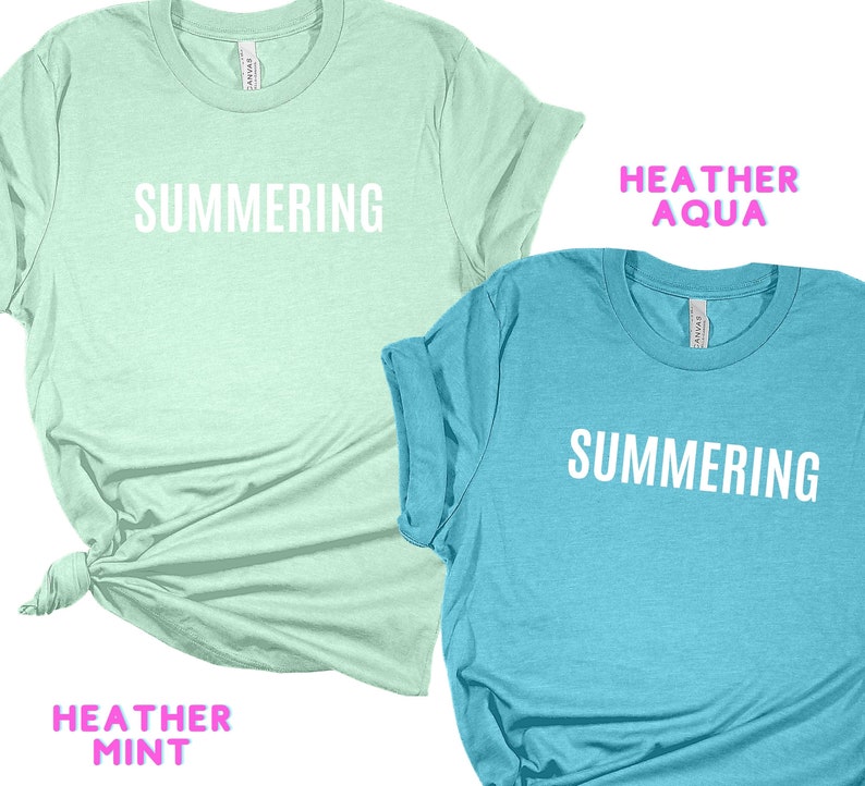 May include: Two t-shirts with the word "SUMMERING" printed on them. The shirt on the left is a light green color with the text "HEATHER MINT" below the design. The shirt on the right is a light blue color with the text "HEATHER AQUA" above the design.