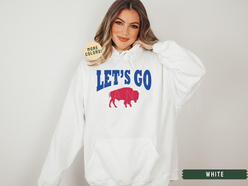 May include: White hooded sweatshirt with the text "Let's Go" in blue and a red buffalo silhouette.