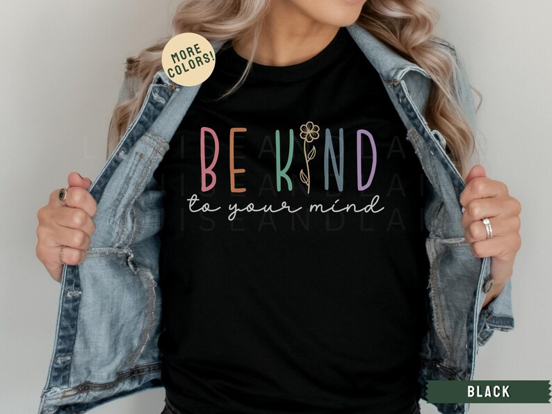 May include: Black t-shirt with the text "BE KIND to your mind" in colorful letters with a flower graphic.