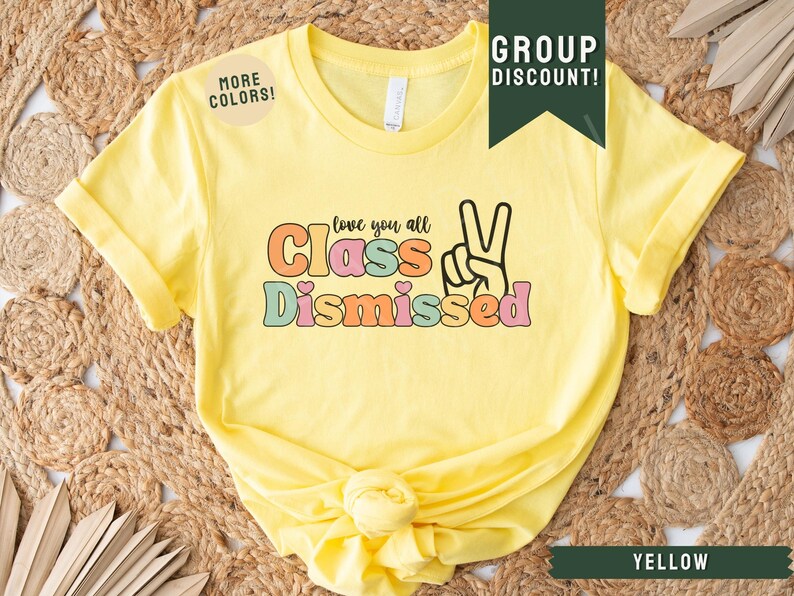 May include: Yellow t-shirt with the text "Love you all Class Dismissed" in colorful letters with a peace sign.