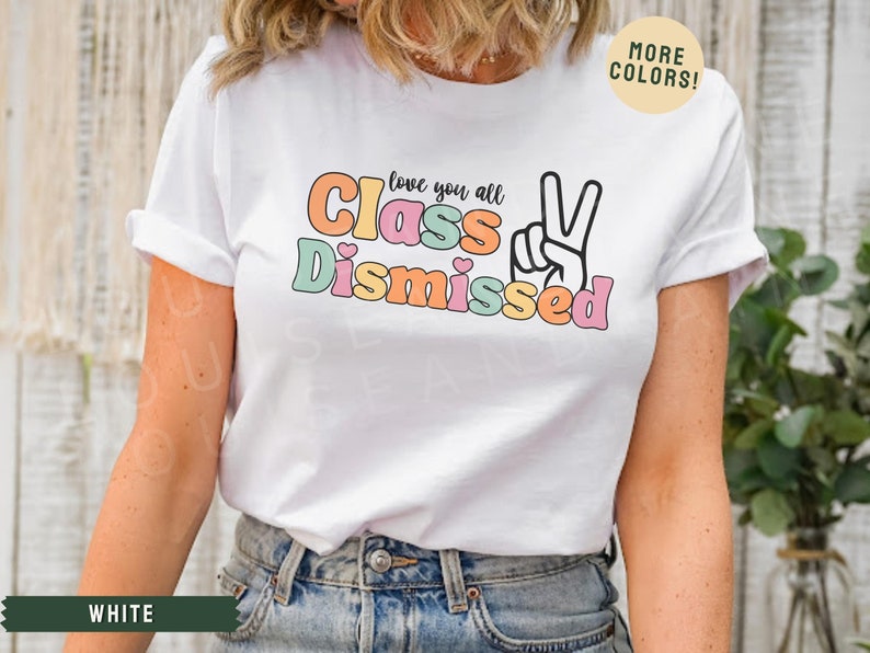 May include: White t-shirt with a colorful graphic that says "Love you all Class Dismissed" with a peace sign.