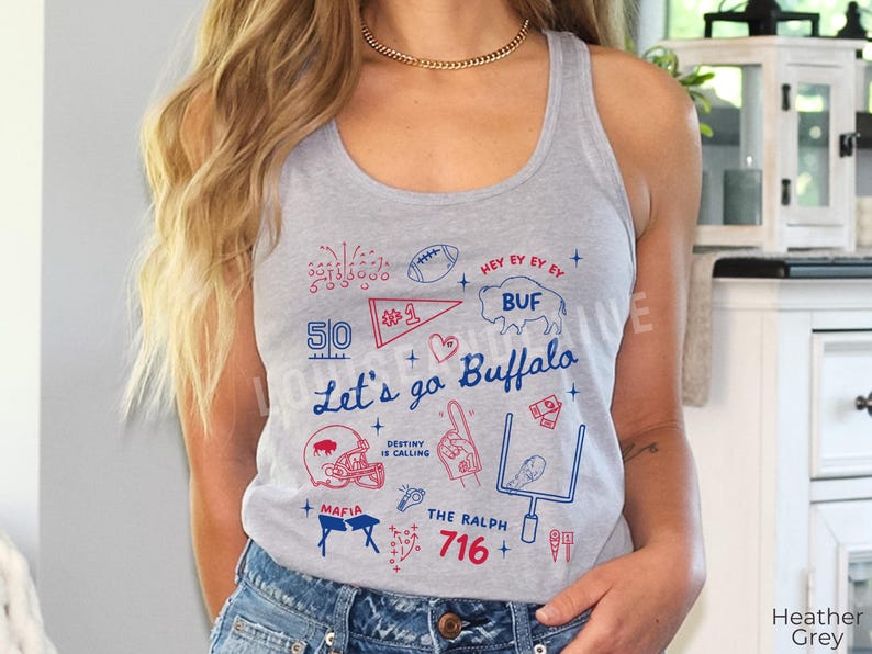 May include: Heather grey tank top with a graphic design in red and blue. The design includes the text "Let's go Buffalo", a football, a helmet, and the number 716. The tank top is sleeveless.