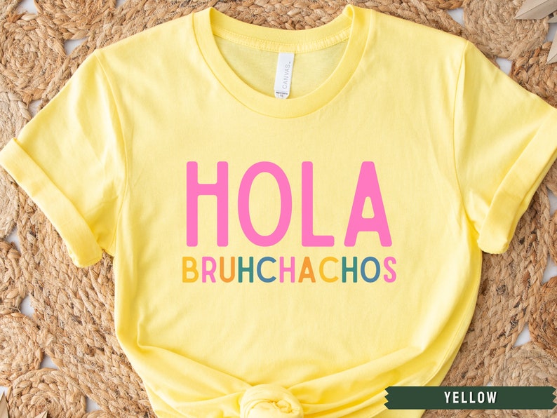 May include: Yellow t-shirt with the text "HOLA BRUHCHACHOS" in pink, orange, yellow, green, and blue letters.