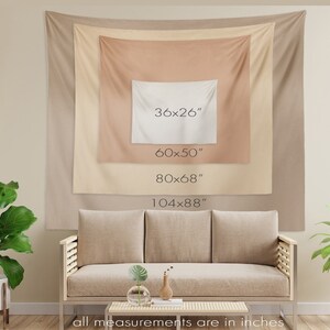 May include: A beige tapestry with four different size options listed in inches. The tapestry is hanging on a wall behind a beige couch.