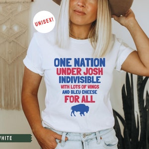 May include: White t-shirt with a blue and red graphic that says "One Nation Under Josh Indivisible with lots of wings and bleu cheese for all". A blue buffalo silhouette is below the text.