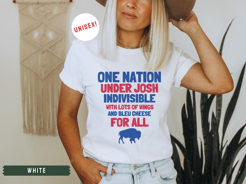 May include: White t-shirt with a blue and red graphic that says "One Nation Under Josh Indivisible with lots of wings and bleu cheese for all". A blue buffalo silhouette is below the text.