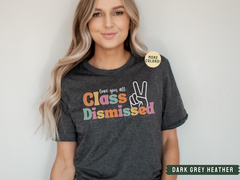 May include: Dark grey heather t-shirt with the text "Love you all Class Dismissed" in colorful letters with a peace sign.