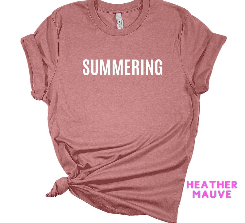 May include: A heather mauve t-shirt with the word "SUMMERING" printed in white on the front.
