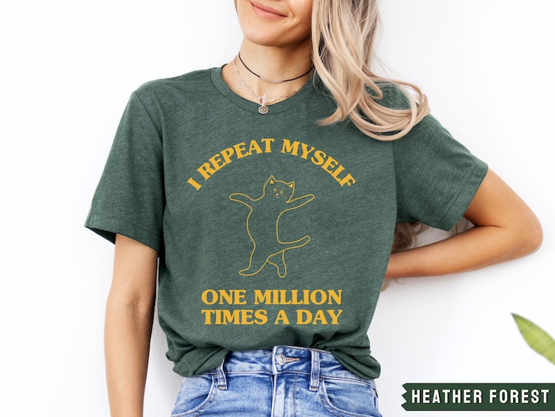 May include: A green t-shirt with a yellow graphic of a cat and the text "I repeat myself one million times a day".