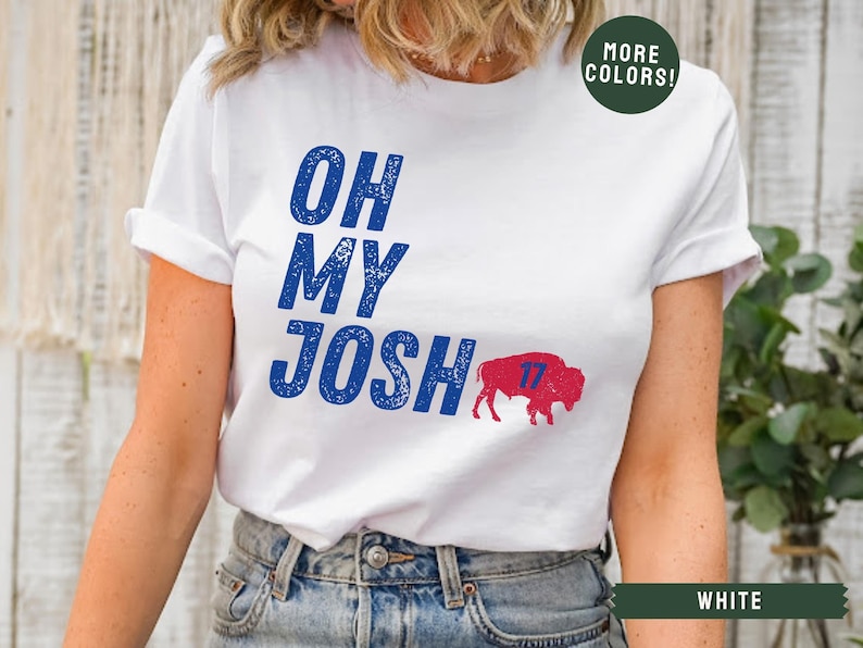 May include: White t-shirt with blue text that reads "Oh My Josh" and a red and blue buffalo with the number 17 on it.