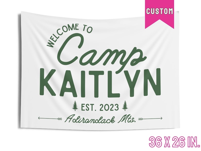 May include: White canvas banner with green text that reads "Welcome to Camp Kaitlyn Est. 2023 Adirondack Mts." The banner is 36 inches by 26 inches.