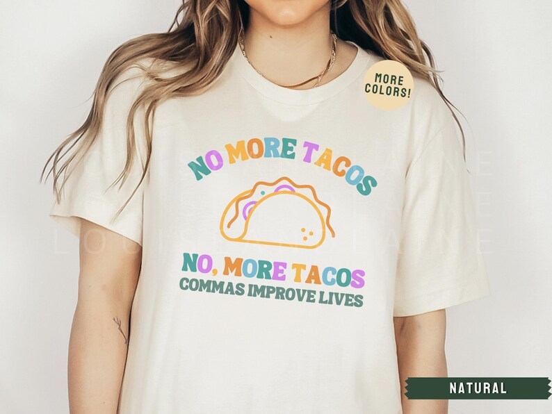 May include: A white t-shirt with the text "NO MORE TACOS, NO, MORE TACOS, COMMAS IMPROVE LIVES" in rainbow colours. A cartoon taco is above the text. A sticker that says "MORE COLORS!" is in the top right corner.