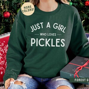 May include: Forest green sweatshirt with the text "Just a girl who loves pickles" in white.