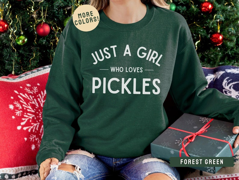 May include: Forest green sweatshirt with the text "Just a girl who loves pickles" in white.