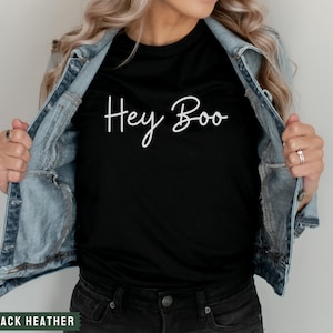 May include: A black t-shirt with the text "Hey Boo" written in white cursive script.