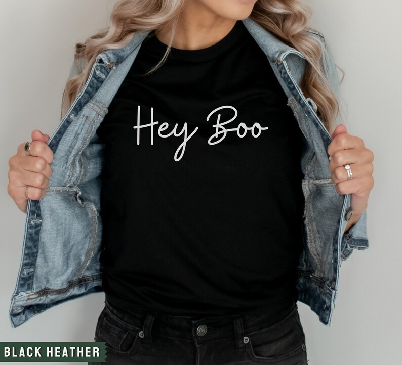 May include: A black t-shirt with the text "Hey Boo" written in white cursive script.