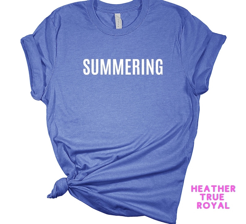 May include: A blue t-shirt with the word "SUMMERING" printed in white on the front.