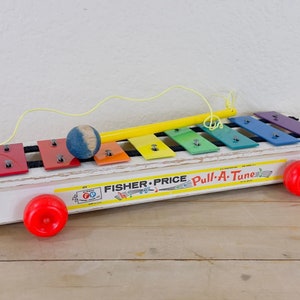1960s Fisher Price Pull-A-Tune Wood Base Xylophone,  Red Plastic Wheels