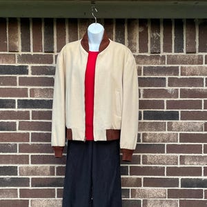 May include: A white ceramic mug with a black handle and the text "But First, Coffee" in a black, bold font. The mug is sitting on a wooden surface. The mug is approximately 4 inches tall.