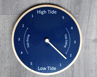 Tide Clock. Blue face with subtle embossed wave effect, birch plywood frame. 21cm (8.26 inches) diameter.