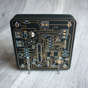 PCB coasters, set of 4 with display stand, black, blue, white or purple printed circuit board. 10 x 10cm x 1.6mm. Gold plated traces.
