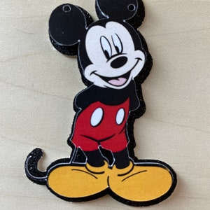 May include: A black and red cartoon character with large ears and yellow shoes. The character is smiling and has a black outline.