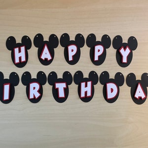 May include: Black and white Mickey Mouse themed banner with the words "Happy 2nd Birthday".