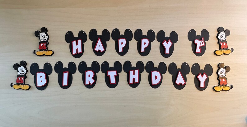 May include: Black and white Mickey Mouse themed banner with the words "Happy 2nd Birthday".