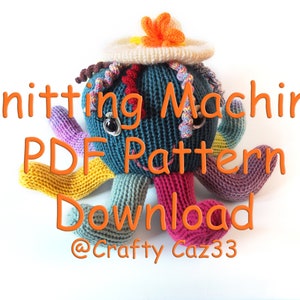 May include: Knitting Machine PDF Pattern Download @Crafty Caz33. A colorful knitted octopus wearing a white crocheted hat with a flower on top.