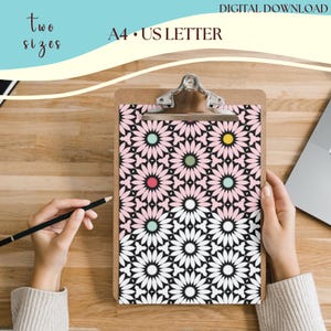 May include: A clipboard with a pink and white geometric pattern featuring stylized flowers. The pattern is on a black background. The text "A4 - US LETTER" is visible at the top of the clipboard.