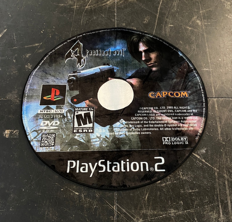 May include: A Resident Evil 4 PlayStation 2 DVD-ROM disc. The disc features a man holding a gun, the game title, and the PlayStation 2 logo. The disc is rated Mature 17+ by the ESRB.