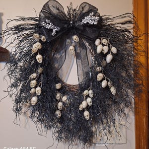 Spooky, elegant black moss and skull wreath