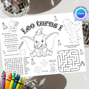 May include: A black and white coloring page featuring Dumbo the elephant, with the text "Leo turns 1". Includes connect-the-dots, a maze, and word puzzles. Crayons are visible in the foreground.