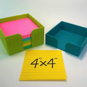 May include: A set of two square desk organizers in green and teal, with a yellow 4x4 inch lined notepad. The green organizer holds a stack of pink, blue, green, and yellow notepaper. The organizers have a textured honeycomb pattern.