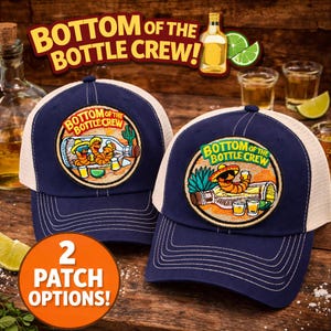 May include: Two navy blue trucker caps with white mesh backs. Each cap has a circular patch with the text "BOTTOM OF THE BOTTLE CREW!" and a cartoon design. The image also includes the text "2 PATCH OPTIONS!"