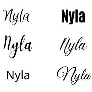 May include: Five variations of the name "Nyla" written in different styles. The name is written in a cursive font, a bold font, and a standard font.