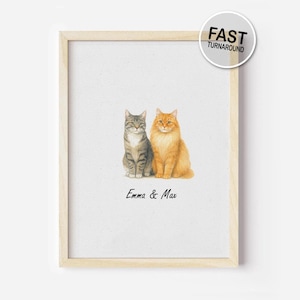 May include: A framed watercolour print of two cats, a grey tabby and an orange long-haired cat, sitting together. The print is labelled "Emma & Max" and includes a "FAST TURNAROUND" sticker.