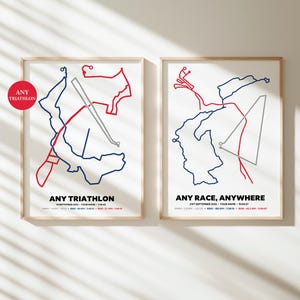 May include: Two framed prints with minimalist triathlon course maps in red, blue, and gray lines on a white background. The text "ANY TRIATHLON" and "ANY RACE, ANYWHERE" are displayed below the maps. The prints are in wooden frames.