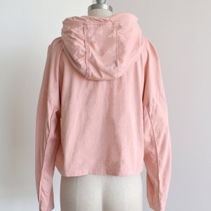 Light pink hoodie in lightweight t-shirt cotton, tonal piping along sleeves and chest, drawstring with silver endings
