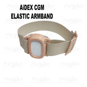 Op de afbeelding: Een beige elastische armband voor een AiDEX CGM-apparaat. Het heeft een perzikkleurige kunststof behuizing. De tekst "AiDEX CGM ELASTIC ARMBAND" staat in het zwart boven de band.