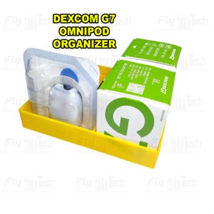 May include: A yellow organizer containing a Dexcom G7 Omnipod and related medical supplies. The organizer holds a white and blue medical device, two green and white boxes, and other medical components. The text "DEXCOM G7 OMNIPOD ORGANIZER" is visible.