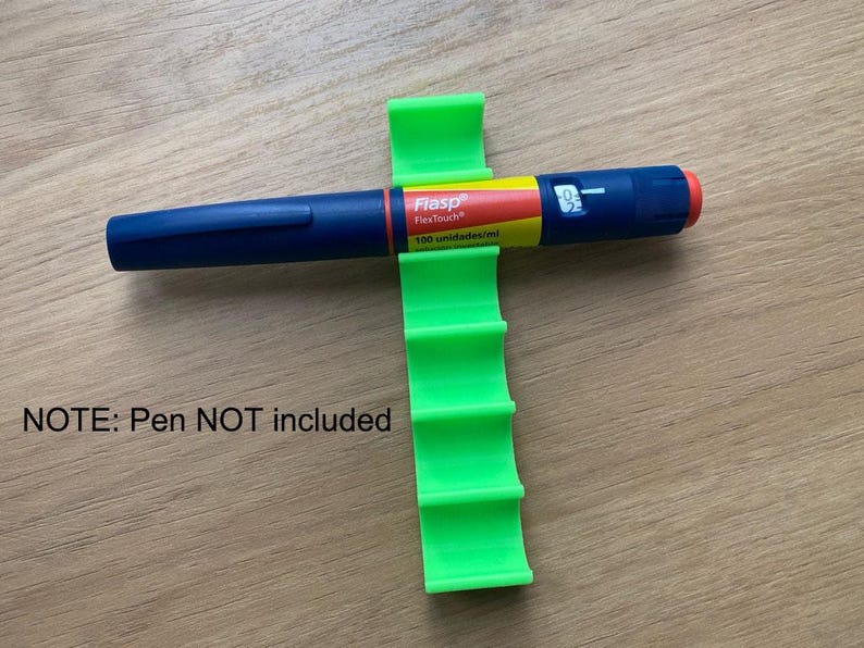 May include: Green plastic pen holder with five slots. The holder is designed to hold insulin pens. The holder is on a wooden surface. NOTE: Pen NOT included.