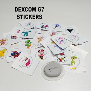 May include: A selection of colourful stickers featuring cartoon characters, animals and symbols. The stickers are designed to be placed on a Dexcom G7 continuous glucose monitor.