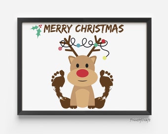 May include: A printable Christmas card featuring a cartoon reindeer with brown antlers and a red nose. The reindeer's legs are made from brown footprints. The card says "Merry Christmas" in brown text with a green holly sprig.