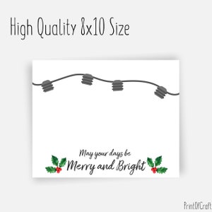 May include: A white printable card featuring a string of grey Christmas lights and the text "May your days be Merry and Bright" with red holly berries and green leaves.
