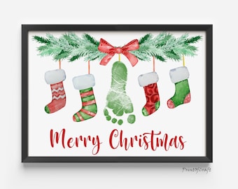 May include: A watercolor Christmas print with a green footprint hanging from a garland of green pine branches with red bows.  The footprint is surrounded by five red and green stockings with white trim. The text "Merry Christmas" is written in red below the stockings.