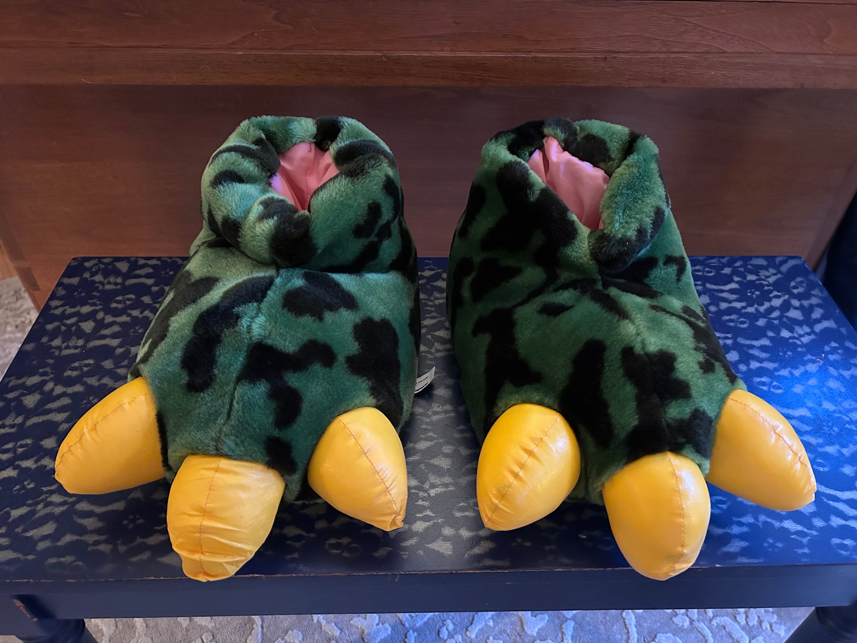 Roaring dinosaur slippers deals
