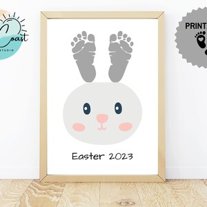 May include: Printable Easter bunny footprint art with grey footprints and a cute bunny face. The text "Easter 2023" is at the bottom of the image.